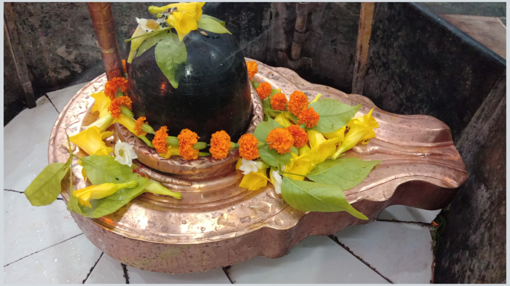 Lord Shiva's Shivling adorned with flowers and belpatra